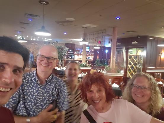 Five people smiling into the camera.