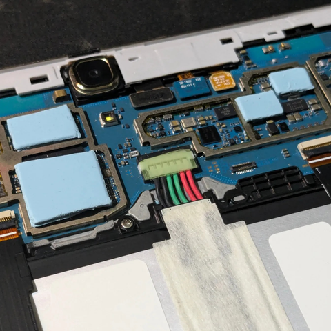 PCB of the Samsung SM-T800 tablet with thermal pads on the CPU and GPU.