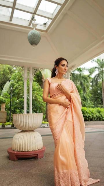 Get inspired by Surabhi Jyothi's latest fashion choice - a beautiful peach floral saree that exudes elegance and sophistication. The delicate floral patterns and soothing peach shade highlight her radiant beauty, creating a perfect blend of traditional and contemporary style. Whether for a wedding, festive occasion, or a formal event, this stylish saree look is sure to turn heads. Explore Surabhi Jyothi's style secrets and elevate your fashion game.