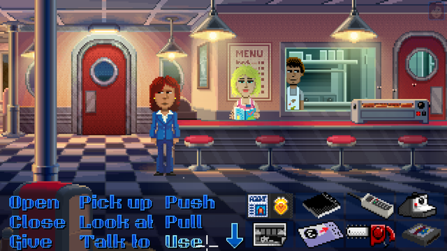 Thimbleweed Park. A 50s-styled diner. Agent Ray, a redhead woman in a blue suit, stands in the middle of the floor. A blonde lady is behind a counter and in the back is a man.