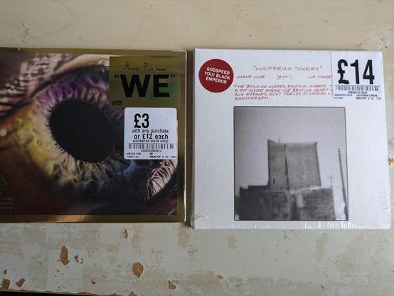 Two CD's. We by Arcade Fire and Luciferian Towers by Godspeed You Black Emperor