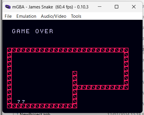 A screen shot of snake, running in the mGBA emulator. Game over with a score of 77.