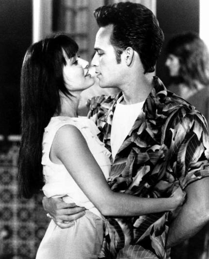 Black and white photo of Dylan McKay and Brenda Walsh, portrayed by Luke Perry and Shannon Doherty, respectively, in Beverly Hills 90210.