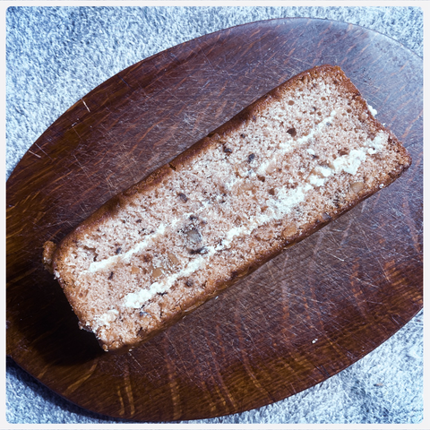 cake. c'est ca. coffee and walnut cake. my cake, photographed on a breadboard shortly before meeting a glorious and heroic end. 