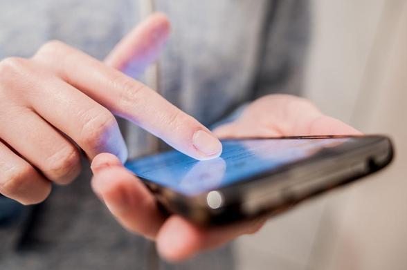 Our new project IMPROVE is developing a framework based on patient-generated information. Image of a person touching a smartphone, image credit: Effective Stock Photos via Shutterstock.