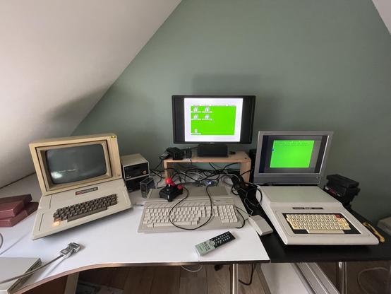 An Apple II, an Atari 520 STe and a Tandy Color Computer 2 all turned on and showing no sign of malfunctionwhatsoever.