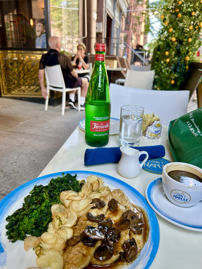 #Fizzy water cafe americano a mini pitcher of cream and a plate of spinach chicken and potatoes 