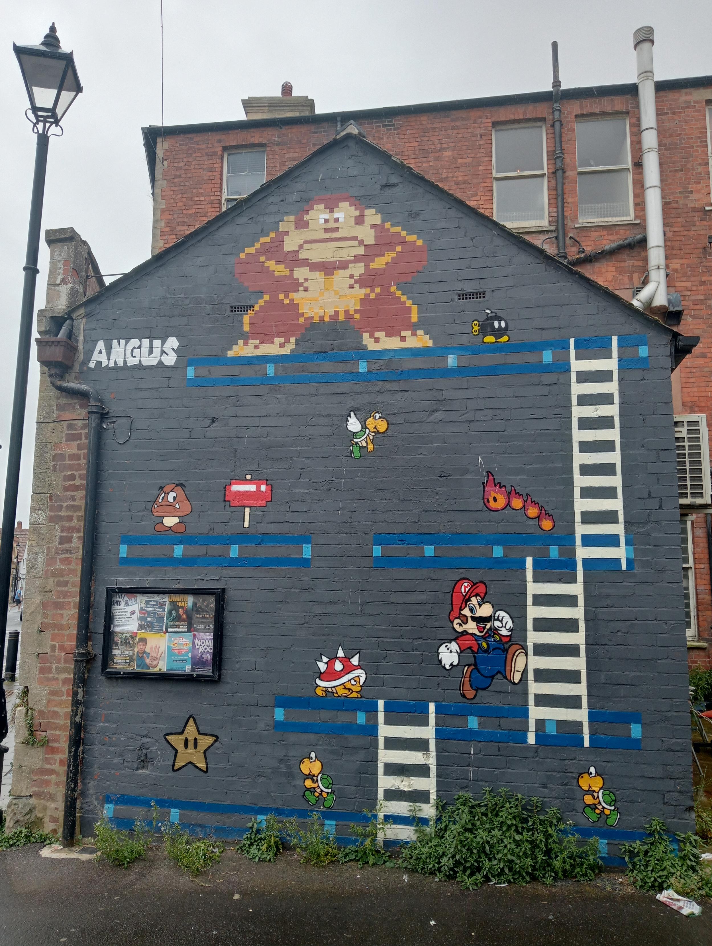 The side of a 2 storey building painted in a huge Nintendo graffiti mural