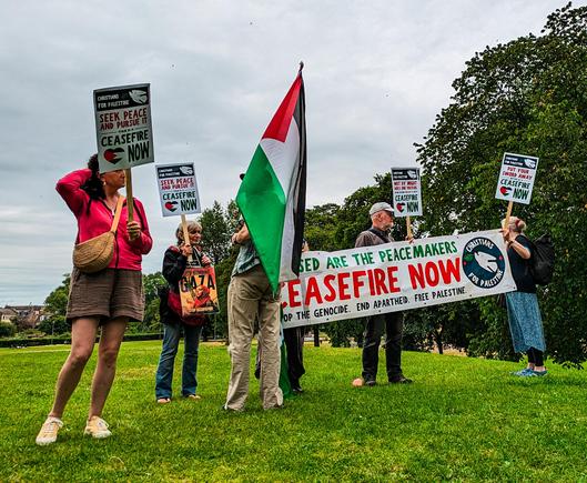 Protesters with Palestinian flag and banners 