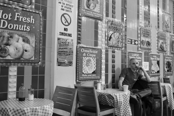 Man sits drinking coffee