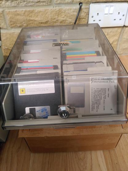 Locking box of floppy discs. The front right one claims to be a best of Microsoft entertainment pack.
