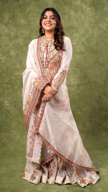 The ever-graceful Aparna Balamurali stuns in a mesmerizing off-white Anarkali suit, epitomizing traditional elegance with a modern touch. The intricate patterns and delicate embroidery on the Anarkali bring out Aparna's timeless beauty and poise. This elegant outfit, perfect for any festive occasion, accentuates her natural charm and sophisticated style. Explore how Aparna blends tradition with contemporary fashion effortlessly, setting new style standards. Discover her look today!