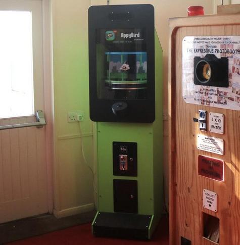 Appybird arcade machine next to the Expressive Photobooth in an arcade. 