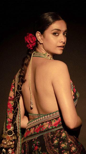 Discover the beauty of Keerthy Suresh's latest fashion statement—a vibrant black floral saree that exudes elegance and charm. The saree's intricate floral design adds a fresh and modern twist to the classic black color, making it perfect for any occasion. Keerthy's graceful pose and radiant smile highlight her natural beauty and impeccable style. This look is a perfect example of how to combine tradition with modern trends. Get inspired by Keerthy's stunning ensemble and elevate your fashion game.