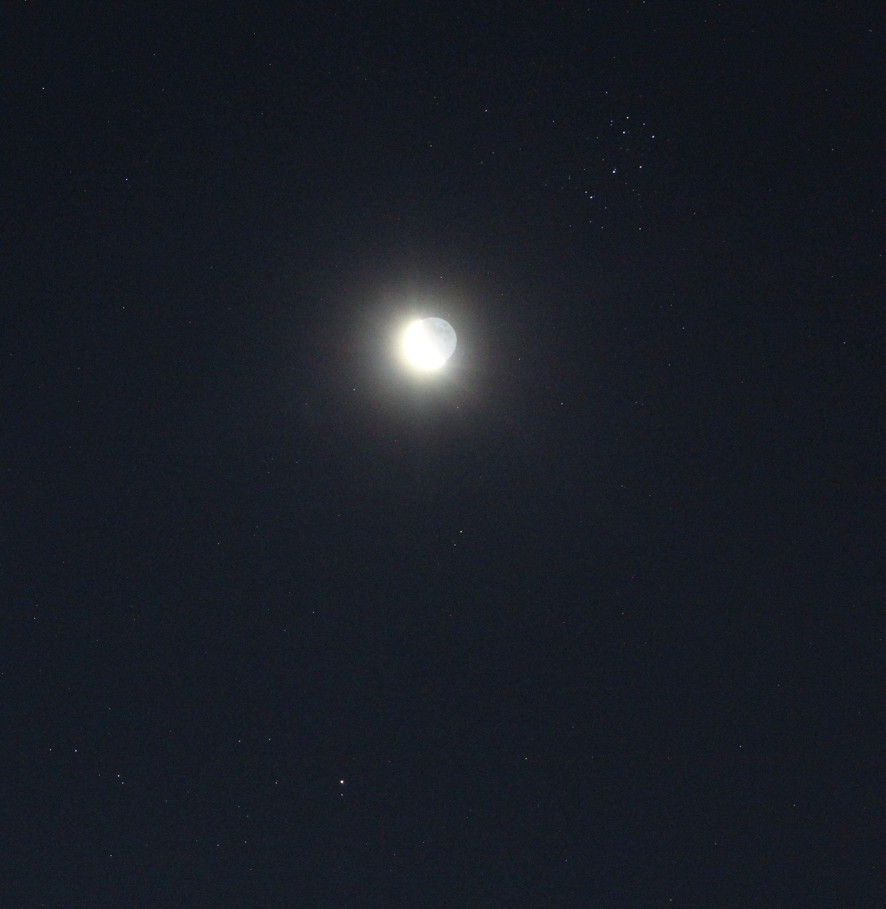 Planet Mars above middle of the bottom edge. The Moon at waning crescent phase above centre. The open star cluster the Pleiades above and to its right. 