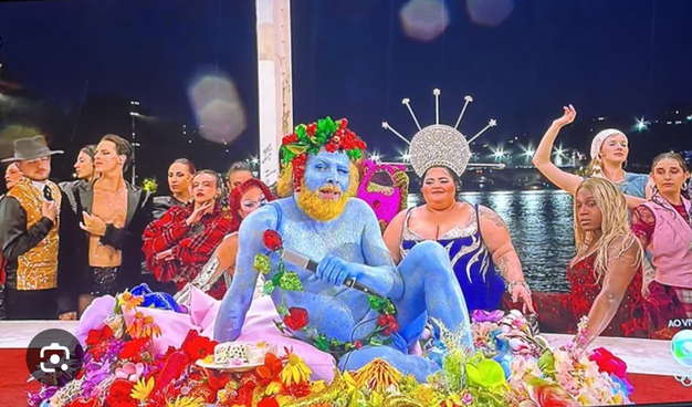 Another photo of Dionysus/Bacchus from the 2024 Summer Olympics Opening Ceremonies. He is now half-reclining on the table, and we can see more of his frolicking companions. I assume they're meant to depict the Maenads.