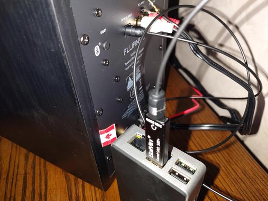 Raspberry Pi 4 (Single Board Computer) in a Flirc Case, connected to a Fluance AI41 speaker via a Saiyin Sound Stick S10+ USB sound card and a TOSLINK optical cable.