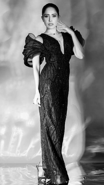 At the recent TOIFA event, Nushrratt Bharuccha stole the spotlight with her mesmerizing black gown. The gown's design highlighted her impeccable fashion sense, with intricate detailing and a silhouette that flattered her figure. Nushrratt's poised demeanor and choice of accessories further elevated her look, making her a standout on the red carpet. This unforgettable ensemble showcases her unique style and timeless elegance.