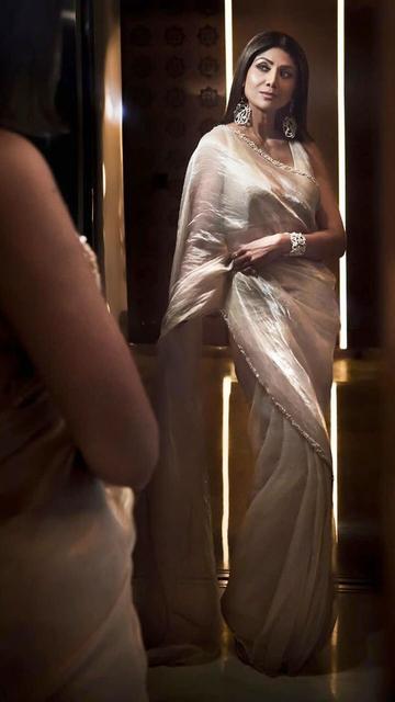 Shilpa Shetty radiates elegance in a golden metallic saree, proving once again that she is a true fashionista. The saree's lustrous fabric and delicate embellishments make her look enchanting, while her poised demeanor adds to the overall charm. Shilpa's fashion choices never fail to impress, and this golden saree is a perfect example. Discover the beauty of Shilpa's latest look and be inspired by her timeless elegance.
