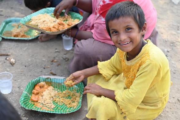 Child happy to have a meal in India