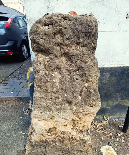 Small standing stone on street corner in Cheltenham