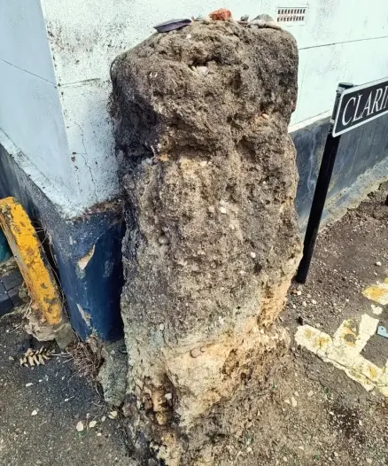 Small standing stone on street corner in Cheltenham