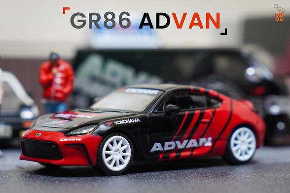 A left side of Toyota GR86 Advan livery by Pop Race in 1:64 scale with 1:64 figure on AREA 164