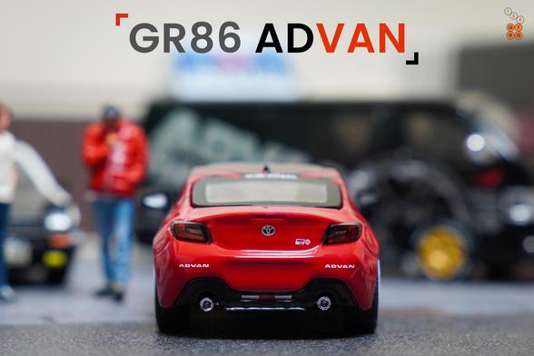 A rear side of Toyota GR86 Advan livery by Pop Race in 1:64 scale with 1:64 figure on AREA 164