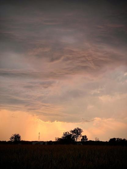 Sunset in between the clouds creating a nice range of tonality and shapes shot at 77 mm