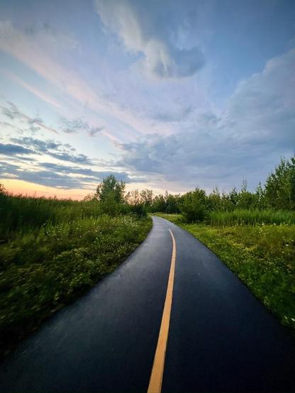 Curved bike path after the rain creating a nice contrast