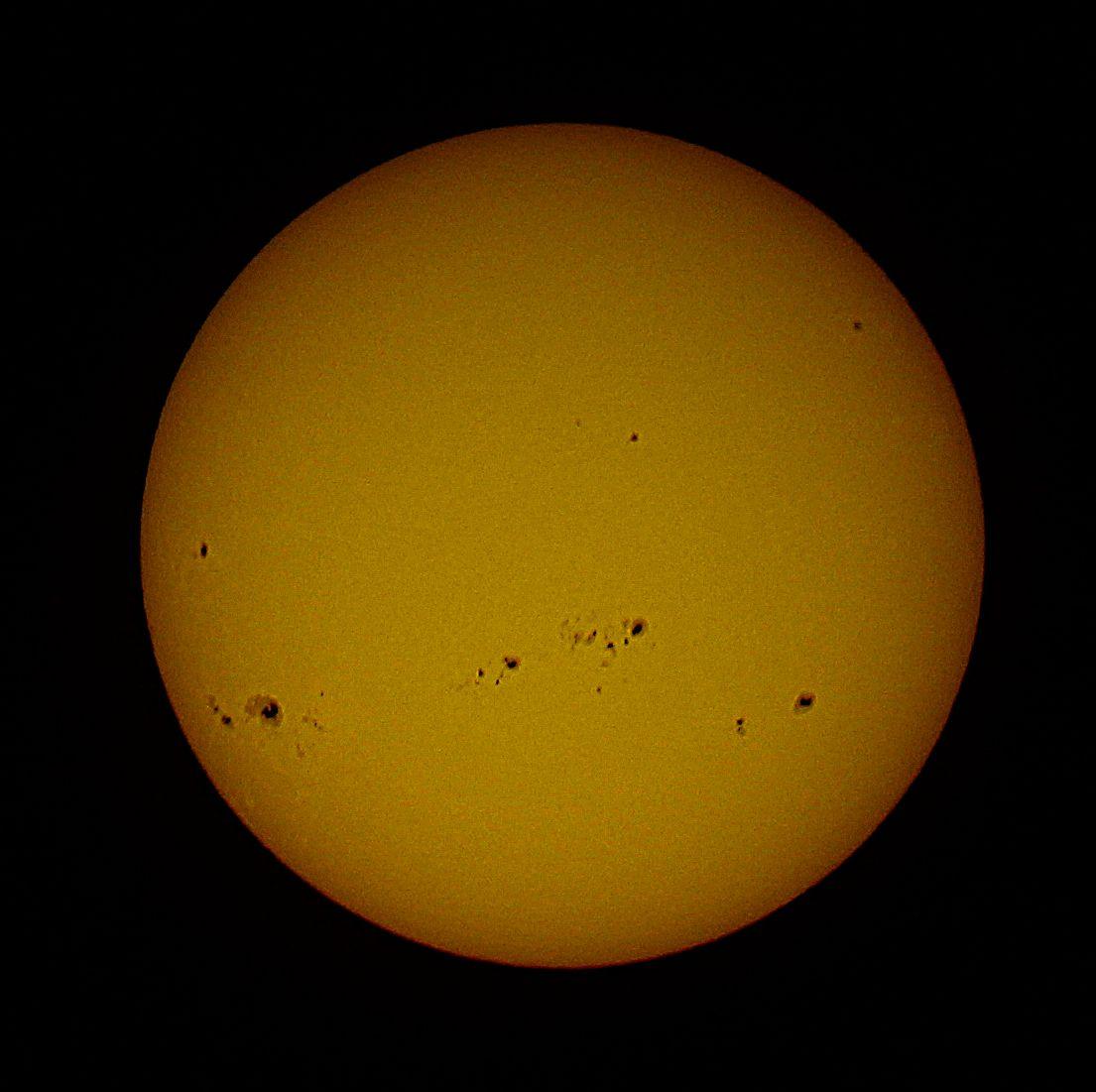 The yellow Sun with spots on a dark background. 