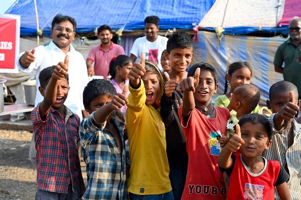 Children giving thumbs up after being feed a meal by One Body Ministries. 