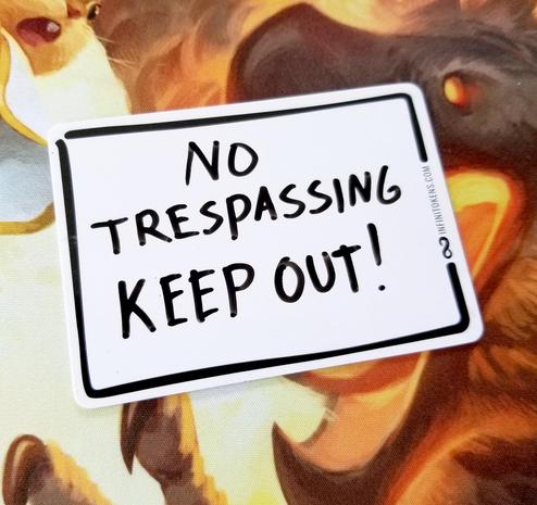 An InfiniToken dry erase token that has "NO TRESSPASSING KEEP OUT" written on it. 