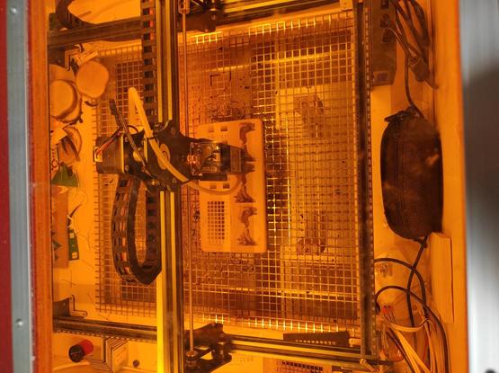 A diode laser burning a test image in a wooden board