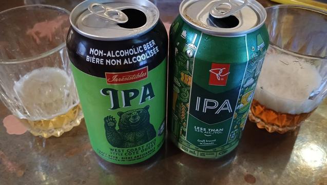 A pair of beer cans and their contents are shown. The Irresistibles one is lighter blonde coloured and the PC one is dark oak coloured.