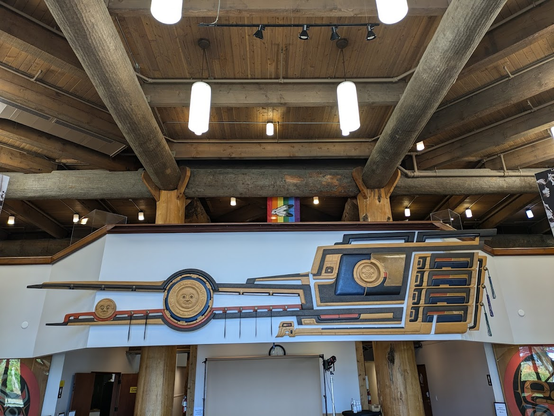 I honestly have no idea what I'm looking at there. It's imposing, dramatic, intense art. A large relief sculpture made from painted wood appears to show maybe the sun and moon, and maybe an abstraction of progress, time, human creativity, history.