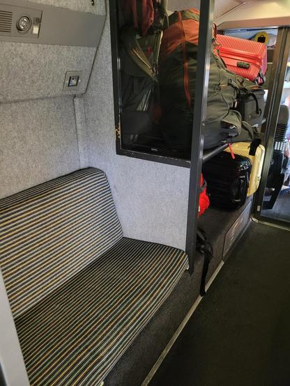 Corridor seat (for making phone calls) with 2 power outlets, and luggage space (full but not too much). Vintage/original design (black/green/yellow horizontal stripes with comfortable seats).