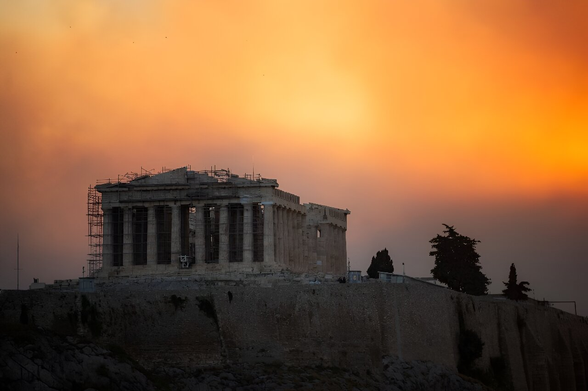 The Parthenon temple atop the Acropolis hill in a cloud of smoke from a wildfire threatening the Athens suburbs.