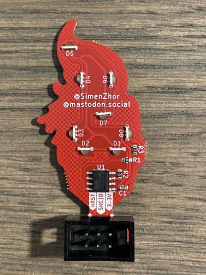 Back view showing all the components, including the cheap PY32F002A MCU and the side-mount SK6805 LEDs that shine through the FR4 substrate to create a glow effect in the eyes and hair of Captain Marvel
