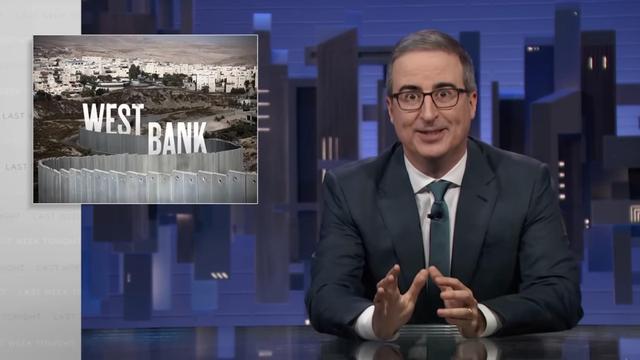 Still from Last Week Tonight featuring John Oliver speaking to the camera from behind a desk.