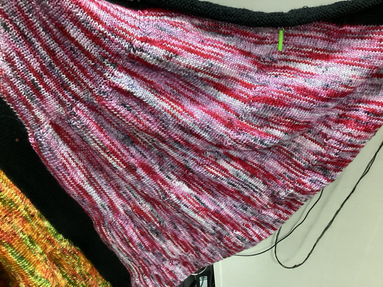 A close up of the red and pink section. Areas of white and grey can be seen  too.