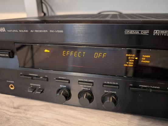 The front of the receiver while on. The left of the display has the DTS logo lit up. The center reads "EFFECT OFF". The right shows the D-TV input selected.