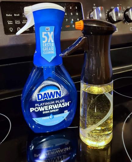 A bottle of Dawn Powerwash sits next to a cooking oil spray bottle. They're nearly identical in size and shape.