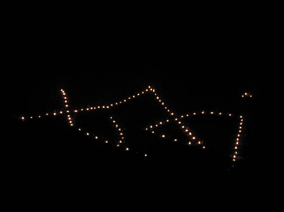 The character 'Myo' being lit on August 16th. At this point you can see the individual bonfires that make up the giant image.