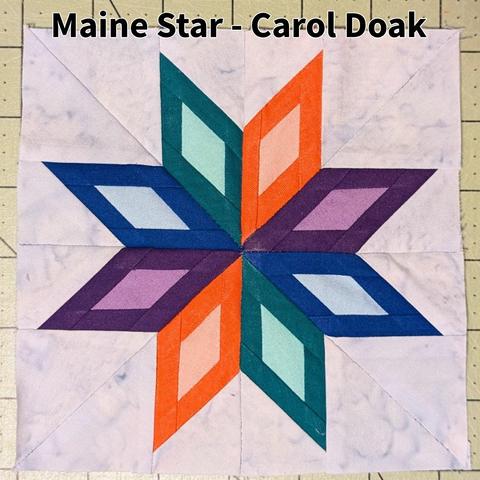 A fabric square featuring an 8-pointed star. The star points have a bit of a stained-glass effect, with a darker edge and lighter inside. The points are orange, purple, blue and green. There are two points of each color. 