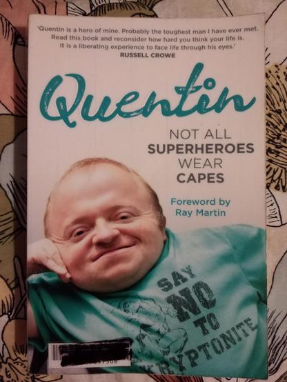 Front cover of Quentin Kenihan's memoir, "Quentin: Not All Superheroes Wear Capes". Quentin assumes a casual pose and wears a turquoise-coloured t-shirt that bears an image of Superman and that reads, "Say no to kryptonite".

At the top of the cover, Russell Crowe is quoted as having said, "Quentin is a hero of mine. Probably the toughest man I have ever met. Read this book and consider how hard you think your life is. It is a liberating experience to face life through his eyes."
