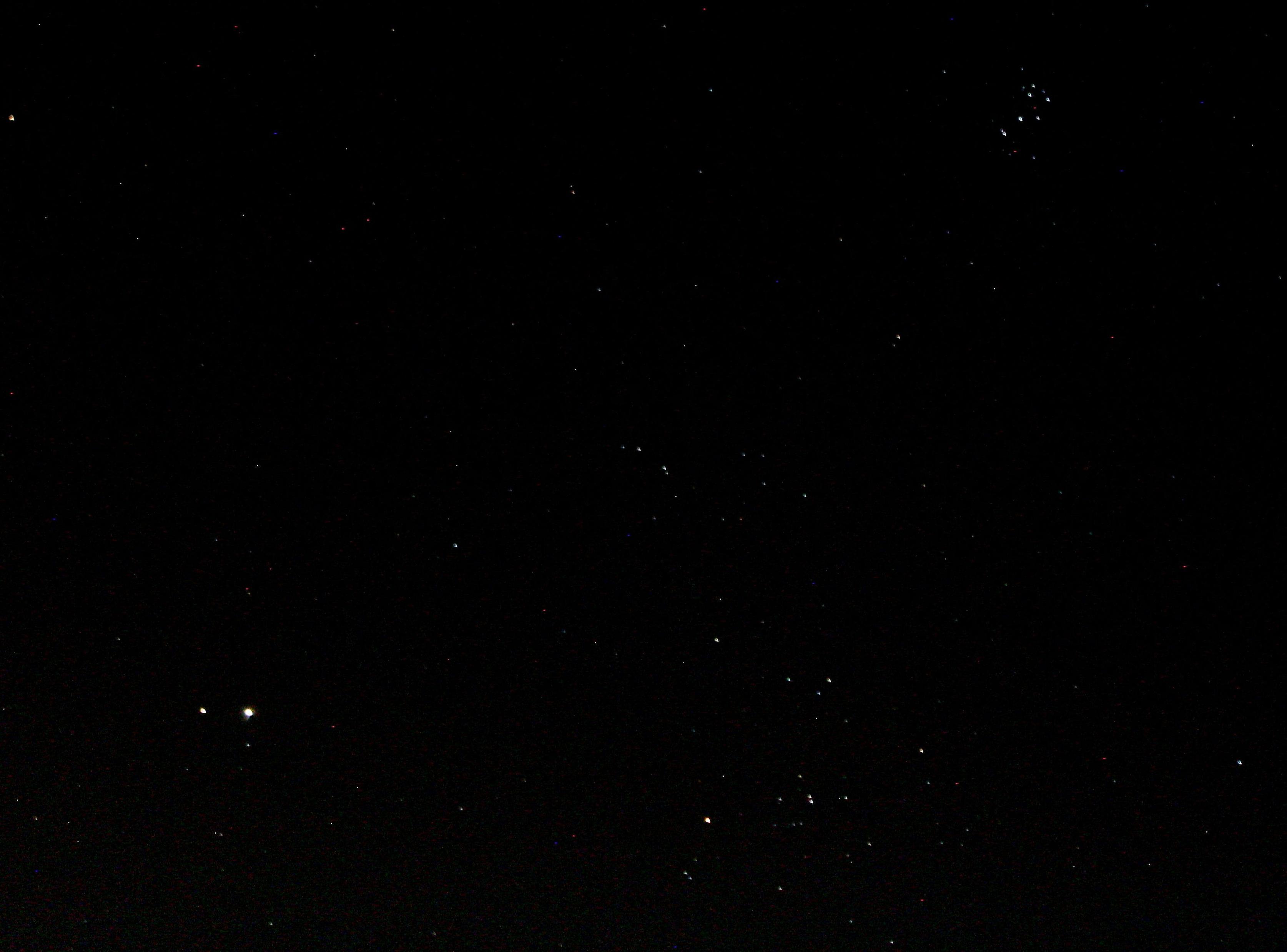 Planets' Mars and Jupiter at lower left corner. Star Aldebaran and star cluster the Hyades above middle of bottom edge. Star cluster the Pleiades at upper right corner. 