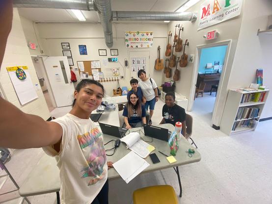 A selfie with three youth near the front, and two teachers in the back.