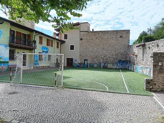Hof der Kirche San Benedetto in Limone sul Garda mit einem kleinen Fußballplatz, der den gesamte Hof ausfüllt.