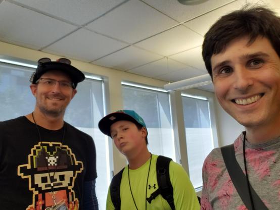 Three people smiling into the camera.